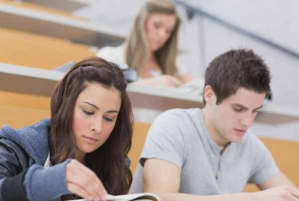 A group of students studying in a lecture hall.