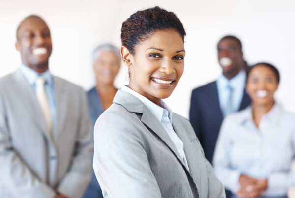 A business woman standing in front of a group of people.